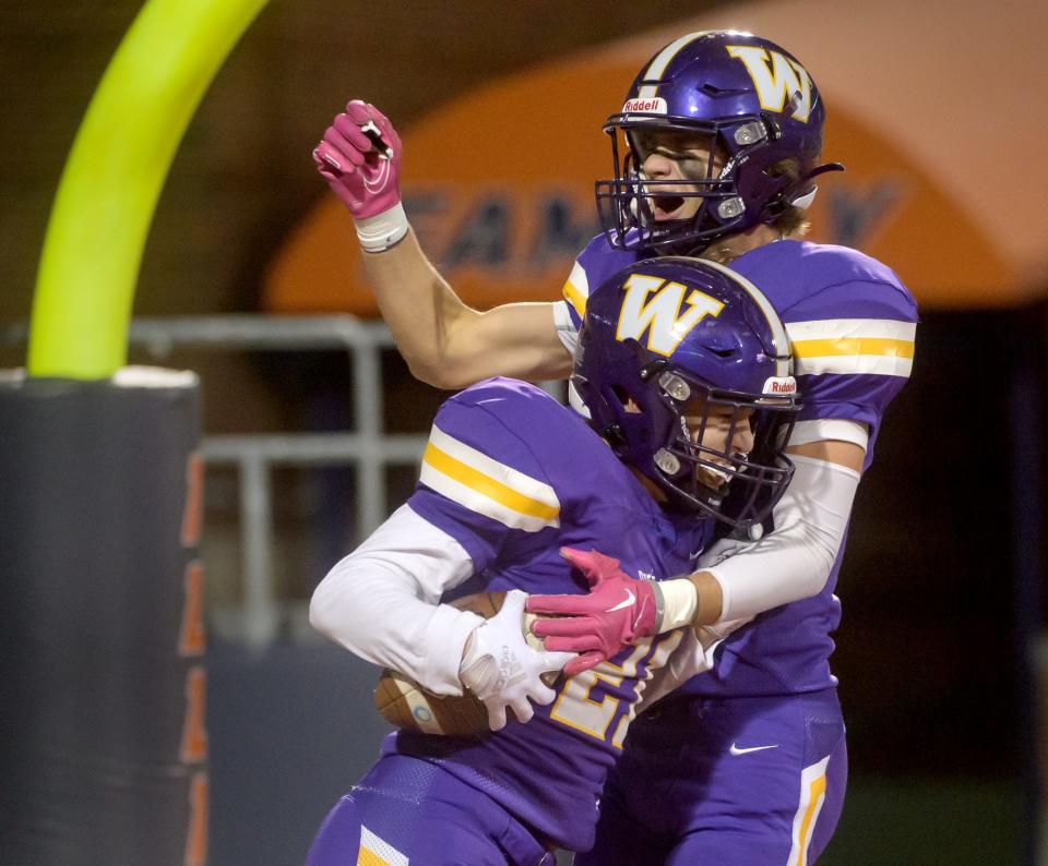 Williamsville's Colvin Fleck, top, and Jackson Workman celebrate Workman's touchdown against IC Catholic in the first half of their Class 3A football state title game Friday, Nov. 25, 2022 in Champaign.