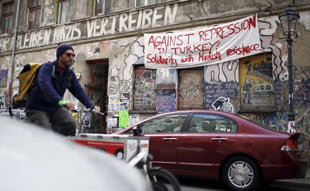 A banner hangs on a squatter house in Berlin, Germany, April 13, 2016. The words read "Against repression in Turkey! Solidarity with Kurdish resistance". REUTERS/Hannibal Hanschke
