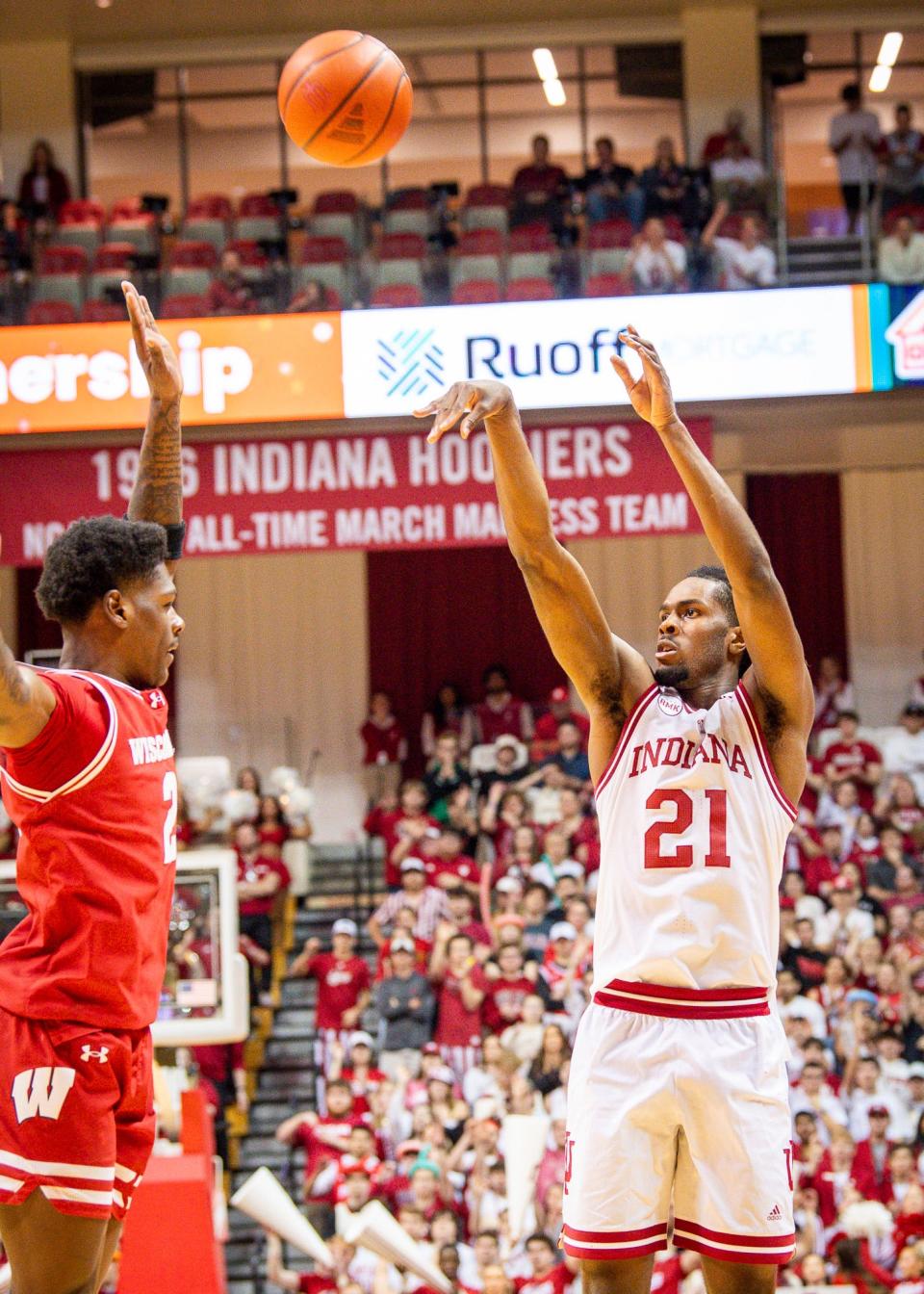 Indiana's Mackenzie Mgbako (21) shoots over Wisconsin's AJ Storr (2) during the second half of the Indiana vs. Wisconsin men's basketball game at Simon Skjodt Assembly Hall on Tuesday, February 27, 2024 .