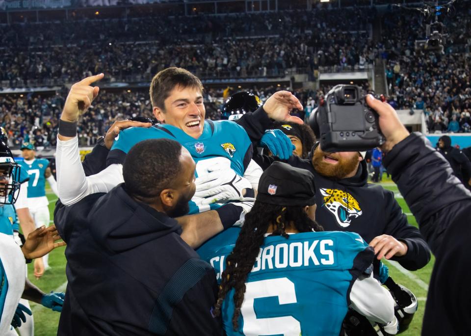 Jan 14, 2023; Jacksonville, Florida, USA; Jacksonville Jaguars kicker Riley Patterson (10) celebrates with teammates after hitting the winning field goal as time expired against the Los Angeles Chargers in the fourth quarter during a wild card game at TIAA Bank Field. Mandatory Credit: Mark J. Rebilas-USA TODAY Sports