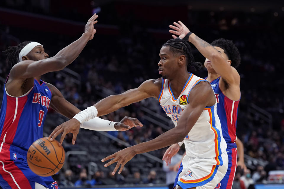 Oklahoma City Thunder guard Shai Gilgeous-Alexander passes the ball during the second half of an NBA basketball game against the Detroit Pistons, Monday, Dec. 6, 2021, in Detroit. (AP Photo/Carlos Osorio)