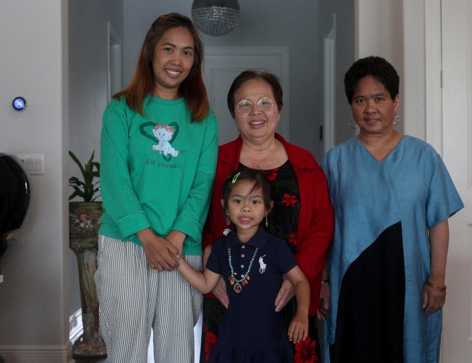Supaporn "Poi" Naknukool (left) holds her daughters hand while posing for a photo with her mother Supee Spindler and sister Nisarat “Nungning” Jittasonthi, April 26, 2023.