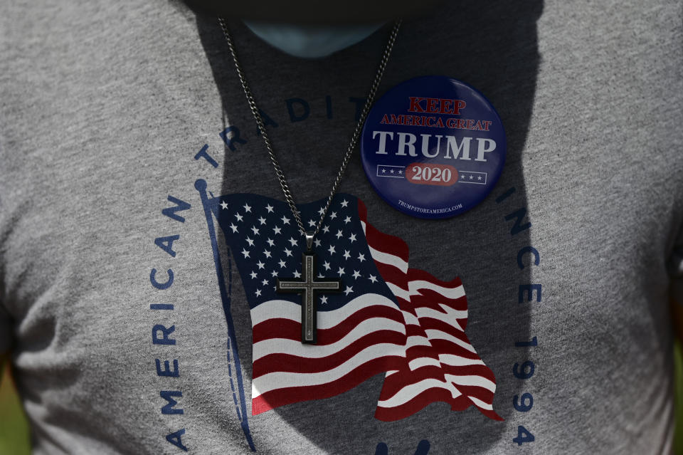 Supporters of president Donald Trump gather moments before leaving for the headquarters of the Republican party in support of his candidacy a few weeks before the presidential election next November, in Carolina, Puerto Rico, Sunday, Oct. 18, 2020. President Donald Trump and former Vice President Joe Biden are targeting Puerto Rico in a way never seen before to gather the attention of tens of thousands of potential voters in the battleground state of Florida. (AP Photo/Carlos Giusti)