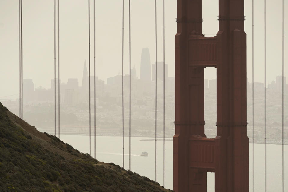 Smoke and haze from wildfires obscure the Golden Gate Bridge and San Francisco skyline in the background near Sausalito, Calif., Wednesday, Aug. 18, 2021. Wind-driven wildfires raged Wednesday through drought-stricken forests in the mountains of Northern California after incinerating hundreds of homes and forcing thousands of people to flee to safety. (AP Photo/Eric Risberg)