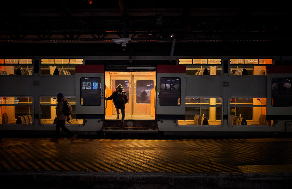 A passenger boards a suburban train at Gare de l'Est Railway Station in Paris as France is hit by widespread traffic disruption with limited services running as transport workers join a nationwide strike on Jan. 19.<span class="copyright">Kiran Ridley—Getty Images</span>