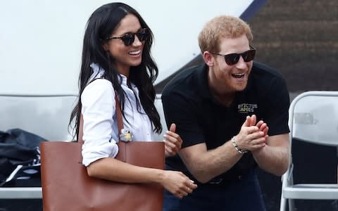 Britain's Prince Harry and his girlfriend actress Markle watch the wheelchair tennis event  - Credit: MARK BLINCH/ REUTERS