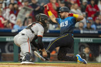 Philadelphia Phillies' Kyle Schwarber, right, slides into home before San Francisco Giants catcher Tom Murphy, left, could get the throw to score a run during the third inning of a baseball game, Friday, May 3, 2024, in Philadelphia. (AP Photo/Chris Szagola)