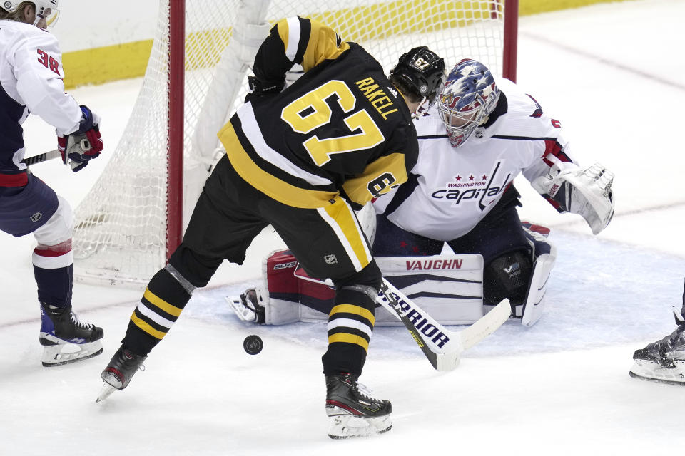 Pittsburgh Penguins' Rickard Rakell (67) cannot get his stick on a rebound in front of Washington Capitals goaltender Darcy Kuemper (35) during the first period of an NHL hockey game in Pittsburgh, Saturday, March 25, 2023. (AP Photo/Gene J. Puskar)