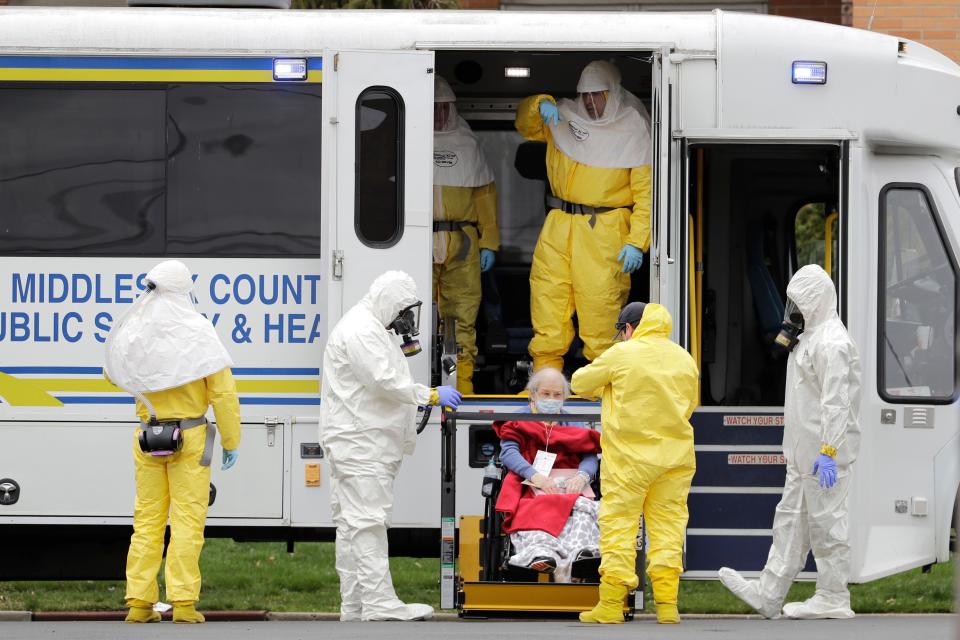 Residents from St. Joseph's Senior Home are helped on to buses in Woodbridge, N.J., Wednesday, March 25, 2020. The pandemic hit the elderly especially hard.