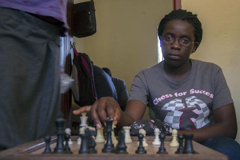 Phiona Mutesi plays a game of chess with her colleagues at the chess academy in Kibuye, Kampala