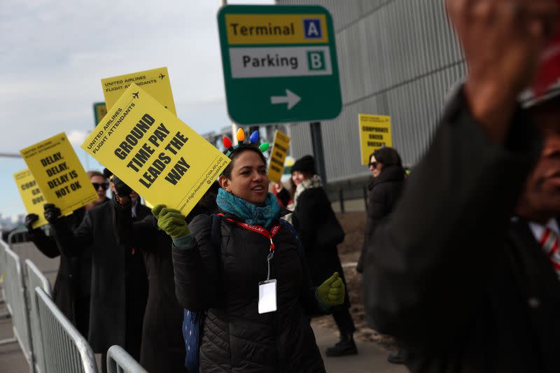 FILE PHOTO: Demonstrators participate in the United Flight Attendants nationwide demonstration to demand fair contract outside LaGuardia Airport in New York City