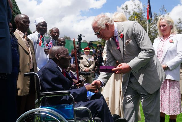 <p> VICTORIA JONES/POOL/AFP via Getty</p> Britain's King Charles meets war veteran Samwel Nthigai Mburia at a Commonwealth War Graves Kariokor Cemetery in Nairobi on November 1.