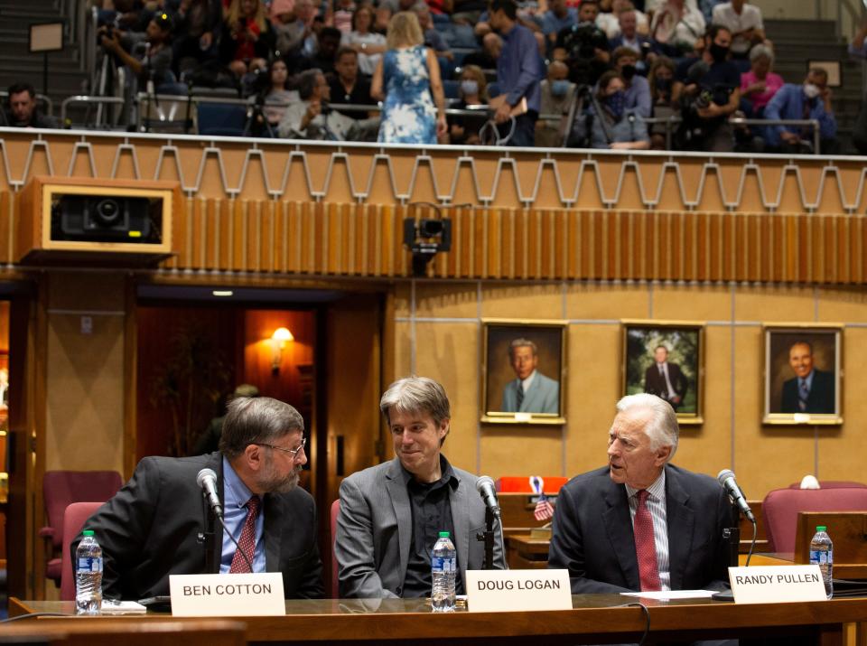 Presenters of the report on the election audit (from left), Ben Cotton, the founder of CyFIR, Doug Logan, the CEO of Cyber Ninjas and Randy Pullen, the audit spokesman, look on before the start of the presentation to the Arizona lawmakers in the Senate chambers of the Arizona Capitol in Phoenix on Sept. 24, 2021.