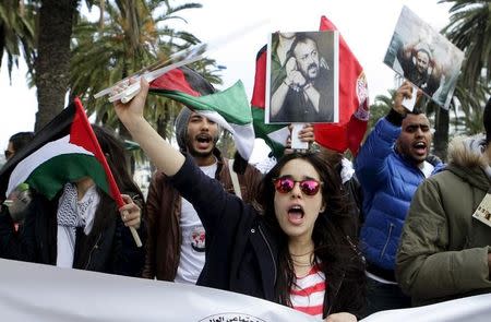 Participants at the World Social Forum hold Palestinian flags during a march at the end of the 2015 World Social Forum (WSF) in solidarity with Palestinians, in Tunis March 28, 2015. REUTERS/Anis Mili