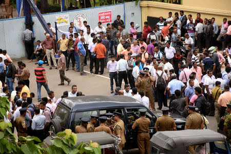 Employees wait in front of the Ceylon Petroleum Corporation building during a strike in Colombo, Sri Lanka July 26, 2017. REUTERS/Stringer