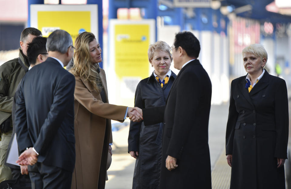 Japanese Prime Minister Fumio Kishida, and Emine Dzhaparova, First Deputy Foreign Minister of Ukraine shake hands at the railway station in Kyiv, Ukraine, Tuesday, March 21, 2023. (Ukrainian Presidential Press Office via AP)