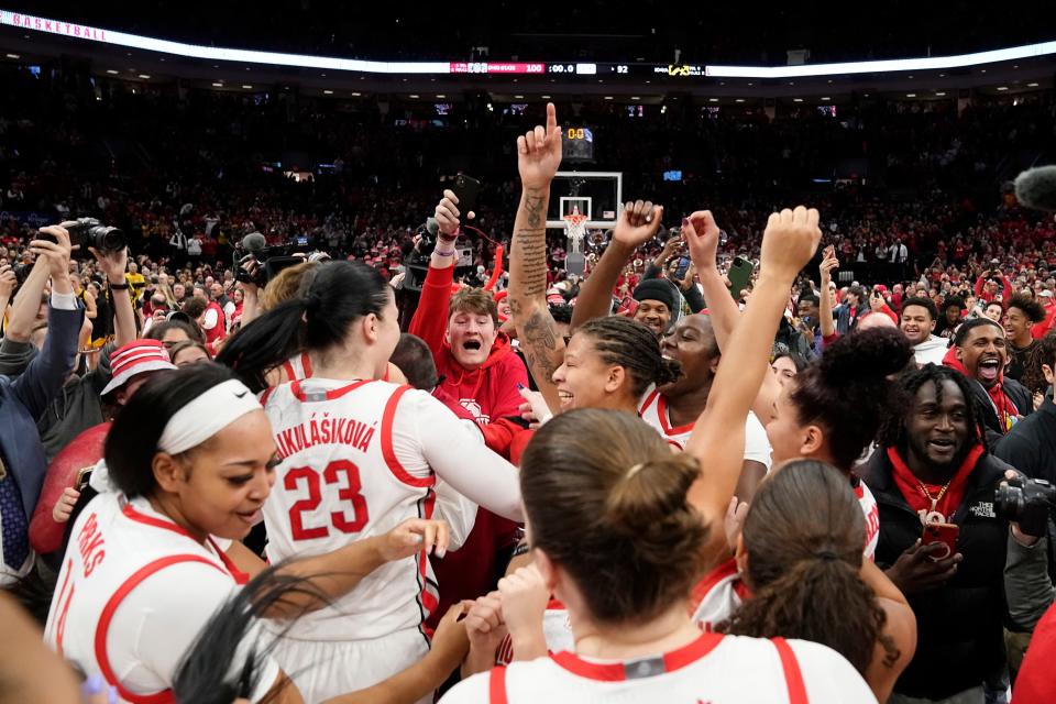 Ohio State players and fans celebrate following Sunday's win over Iowa.