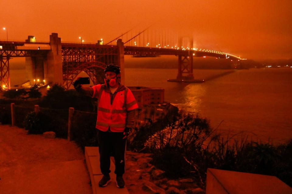 File: Dark orange skies over the Golden Gate Bridge at midday in San Francisco due to smoke from massive wildfires in 2020.