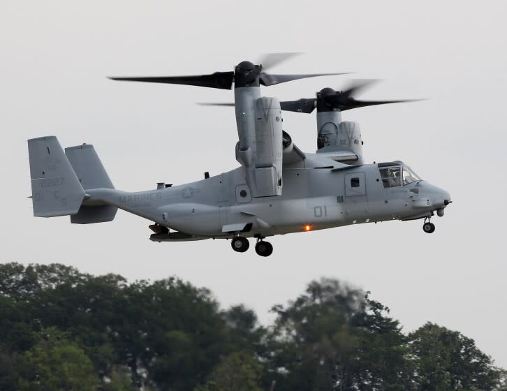 FILE - In this Aug. 3, 2012 file photo, Japan Defense Minister Satoshi Morimoto, not in photo, views the MV-22B Osprey tiltrotor aircraft, at Marine Corps Air Facility at Marine Corps Base in Quantico, Va. The United States and Japan have reached an agreement that allows the MV-22 Osprey to begin flight operations in Japan, officials said Wednesday, Sept. 19, 2012. (AP Photo/Haraz N. Ghanbari, File)