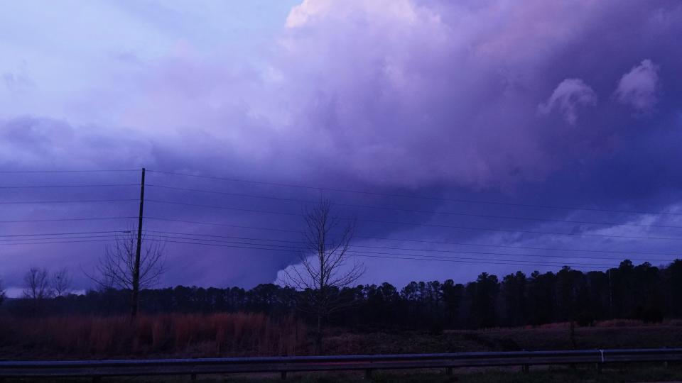 Storm clouds are seen in the distance near Covington, Ga., Friday, Dec. 31.