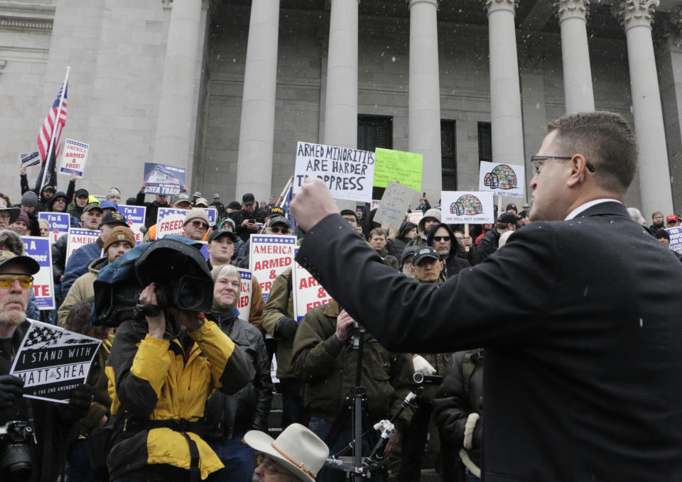 Republican Rep. Matt Shea speaks at a gun-rights rally, where many gathered in support of the embattled lawmaker, in Olympia, Wash., Friday, Jan. 17, 2020. Shea was suspended from the Republican caucus in the wake of a December report that found he was involved in anti-government activities and several lawmakers have called on him to resign. Shea, who says he's been targeted for his work against anti-gun bills, says he will not resign and will run for re-election this year. (AP Photo/Rachel La Corte)