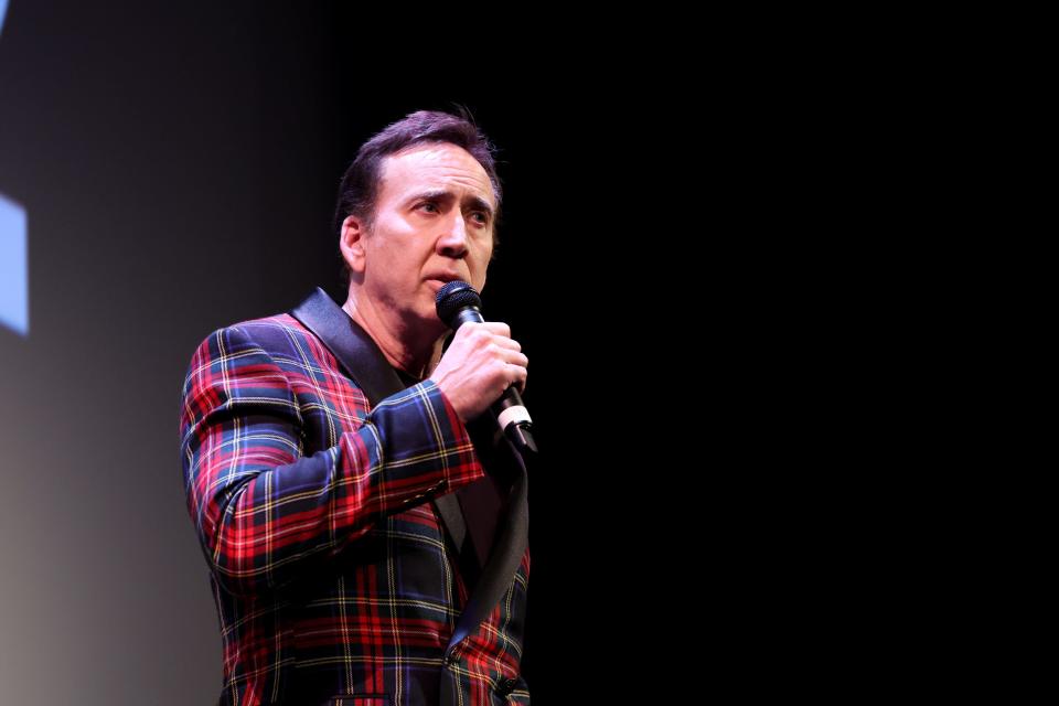 Nicolas Cage holding a microphone