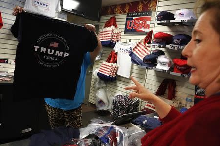 A delegate chooses a Donald Trump campaign t-shirt in a Republican National Convention merchandise store before the final session of the Republican National Convention in Cleveland, Ohio, U.S. July 21, 2016. REUTERS/Jonathan Ernst