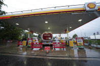 A fuel delivery is made to a petrol station which had run out of fuel after an outbreak of panic buying in the UK, in Manchester, England Monday, Sept. 27, 2021. British Prime Minister Boris Johnson is said to be considering whether to call in the army to deliver fuel to petrol stations as pumps ran dry after days of panic buying. ( AP Photo/Jon Super)