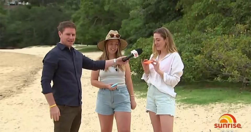 Sunrise hosts Nat Barr and Michael Usher cross to weather reporter Sam Mac on location at Balmoral beach in Sydney. Photo: Channel 7.