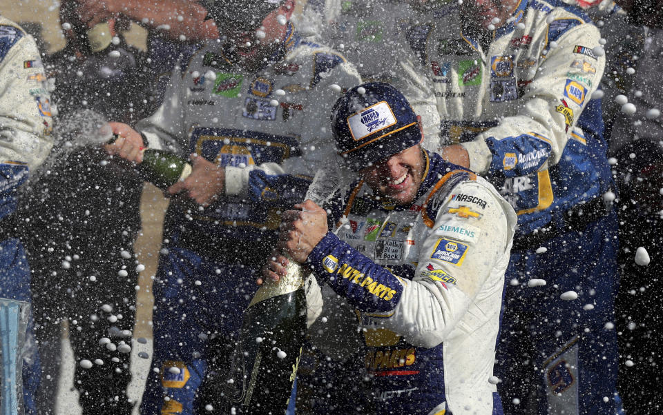 Chase Elliott celebrates his victory with his pit crew after winning a NASCAR Cup Series auto race at Watkins Glen International, Sunday, Aug. 4, 2019, in Watkins Glen, N.Y. (AP Photo/John Munson)