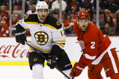 Oct 15, 2014; Detroit, MI, USA; Boston Bruins left wing Simon Gagne (12) defended by Detroit Red Wings defenseman Brendan Smith (2) in the second period at Joe Louis Arena. (Rick Osentoski-USA TODAY Sports)