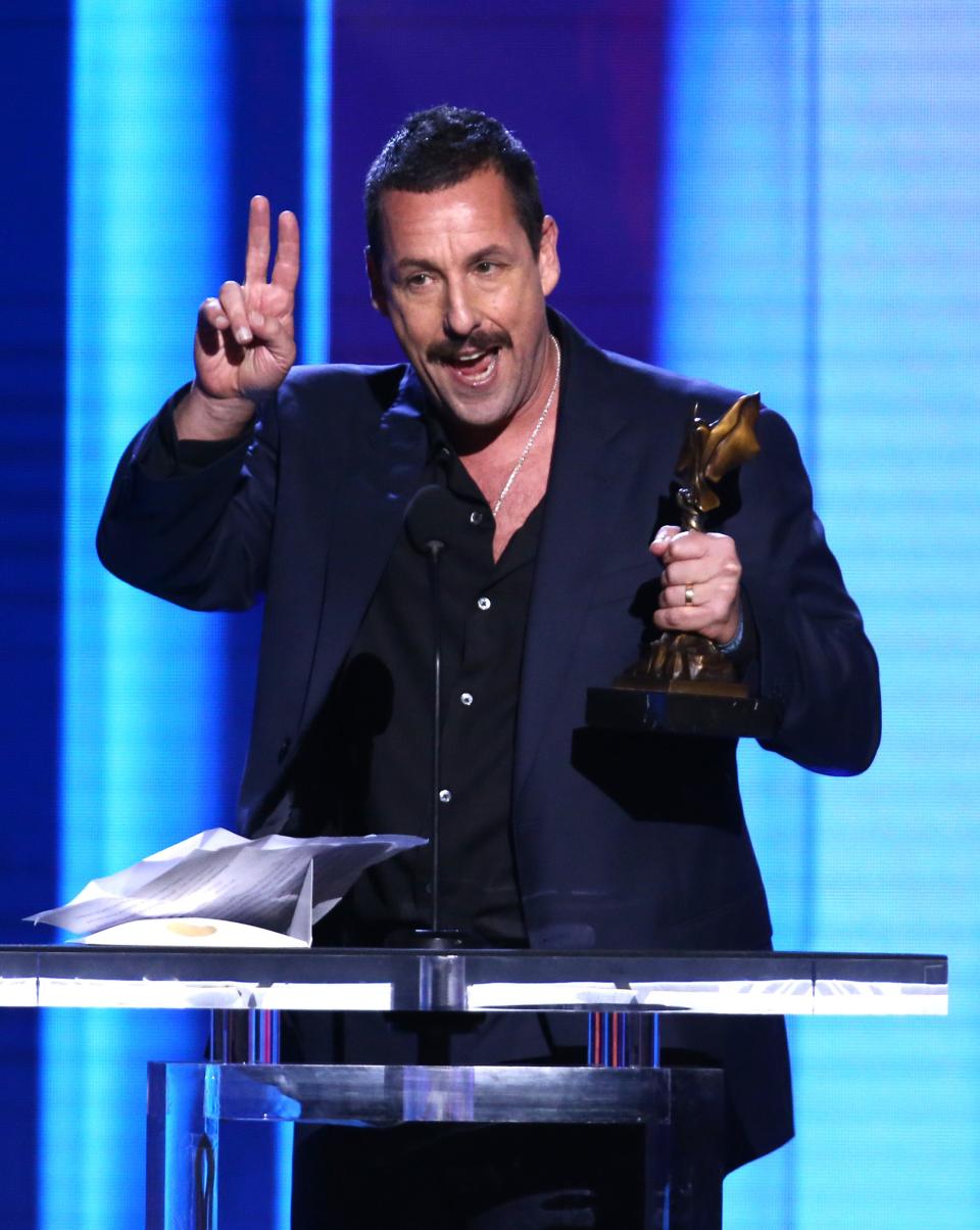 A day before the Oscars, Adam Sandler accepts the Spirit Award for best male lead.