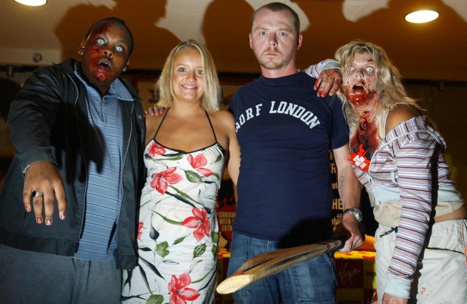 Actors Lucy Davis and Simon Pegg (centre left and right) pose alongside two 'zombies' during an in-store appearance at Virgin Megastore on Piccadilly, central London  to sign copies of the new Shaun Of The Dead DVD, which was realeased today.   (Photo by Andy Butterton - PA Images/PA Images via Getty Images)