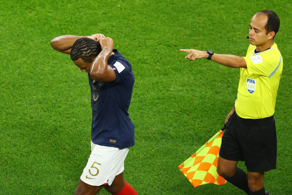 Soccer Football - FIFA World Cup Qatar 2022 - Round of 16 - France v Poland - Al Thumama Stadium, Doha, Qatar - December 4, 2022 France's Jules Kounde removes jewellery REUTERS/Lee Smith