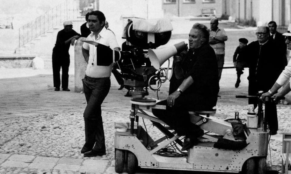 Giuseppe Rotunno, left, and Federico Fellini, centre seated, on a film set in 1973.