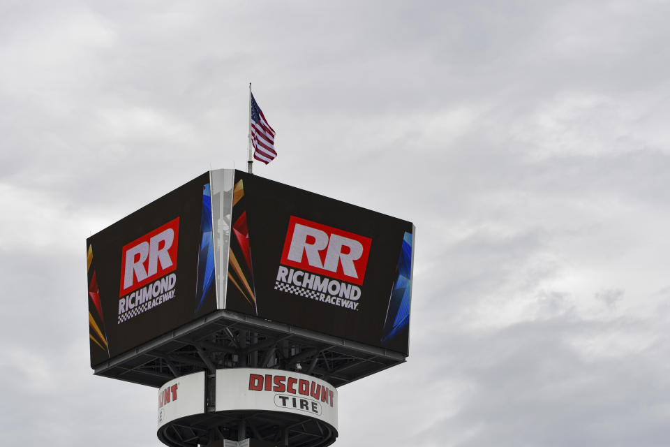 The American flag flies above the pole position sign before the start of the NASCAR Xfinity Series auto race at Richmond Raceway, Saturday, April 1, 2023, in Richmond, Va. (AP Photo/Mike Caudill)