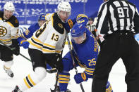 Buffalo Sabres forward Arttu Ruotsalainen (25) and Boston Bruins forward Charlie Coyle (13) battle for position during the second period of an NHL hockey game, Tuesday, April 20, 2021, in Buffalo, N.Y. (AP Photo/Jeffrey T. Barnes)