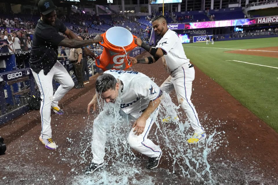 Miami Marlins' Joey Wendle is doused after two runs scored on his single and a throwing error by St. Louis Cardinals relief pitcher Jordan Hicks during the ninth inning of a baseball game Wednesday, July 5, 2023, in Miami. (AP Photo/Lynne Sladky)