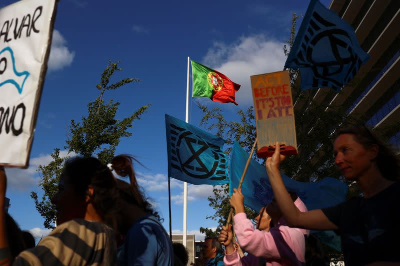 Activists take part in the 'Blue Climate March' outside the UN Ocean Conference in Lisbon to urge world leaders to act and protect the environment, in Lisbon