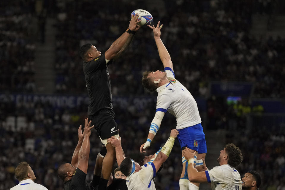 New Zealand's Shannon Frizell, left, takes a line out during the Rugby World Cup Pool A match between New Zealand and Italy at the OL Stadium in Lyon, France, Friday, Sept. 29, 2023. (AP Photo/Pavel Golovkin)