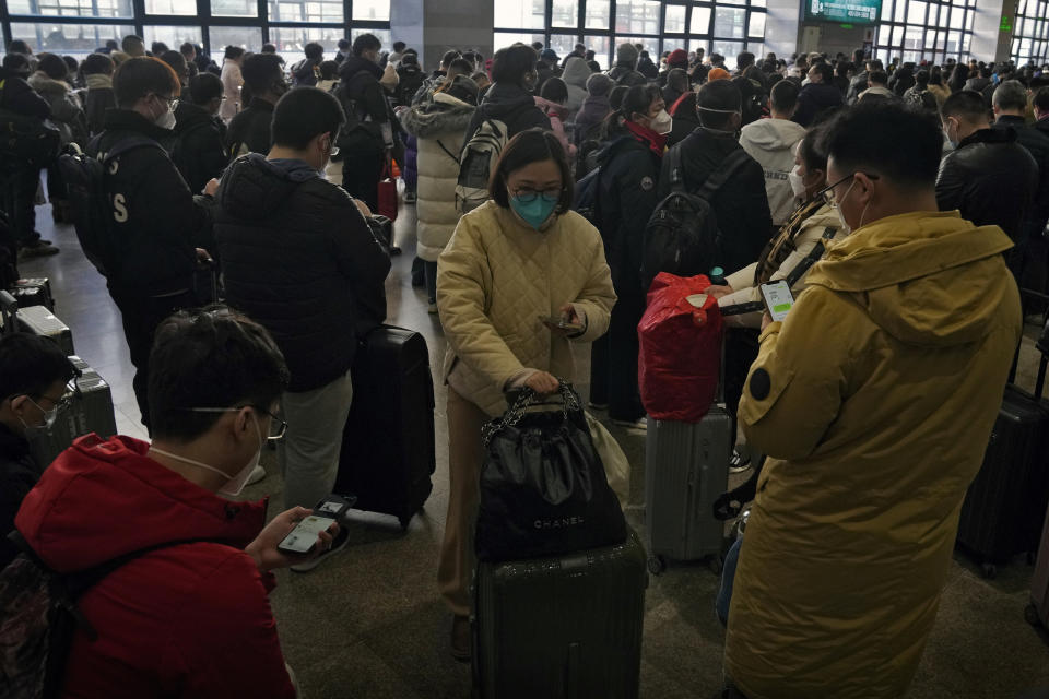 Travelers wearing face mask gather at a departure hall as they prepare to catch their trains at the West Railway Station in Beijing, Sunday, Jan. 15, 2023. The World Health Organization has appealed to China to keep releasing information about its wave of COVID-19 infections after the government announced nearly 60,000 deaths since early December following weeks of complaints it was failing to tell the world what was happening. (AP Photo/Andy Wong)