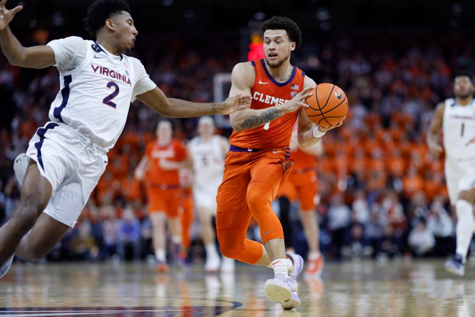 Feb 28, 2023; Charlottesville, Virginia, USA; Clemson Tigers guard Chase Hunter (1) drives to the basket as Virginia Cavaliers guard Reece Beekman (2) defends in the first half at John Paul Jones Arena. Mandatory Credit: Geoff Burke-USA TODAY Sports