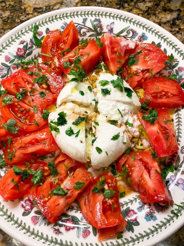 <p>The Brunette Nomad</p><p>If you’re looking for a different take on a caprese salad or simply love cheese, consider making a burrata Caprese salad this summer.</p><p><strong>Get the recipe: <a href="https://thebrunettenomad.com/2020/06/burrata-caprese-salad-low-calorie-summer-salad.html/" rel="nofollow noopener" target="_blank" data-ylk="slk:Burrata Caprese Salad;elm:context_link;itc:0;sec:content-canvas" class="link rapid-noclick-resp"><em>Burrata Caprese Salad</em></a></strong></p>