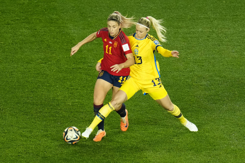 Spain's Alexia Putellas, left, and Sweden's Amanda Ilestedt fight for the ball during the Women's World Cup semifinal soccer match between Sweden and Spain at Eden Park in Auckland, New Zealand, Tuesday, Aug. 15, 2023. (AP Photo/Abbie Parr)