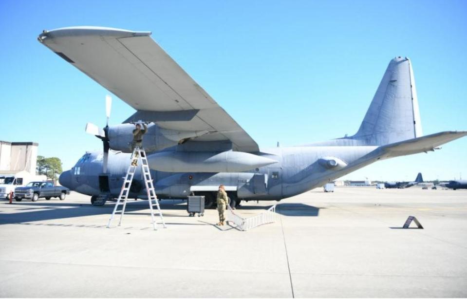 U.S. Air Force Airman 1st Class Kristina Fields, 4th Aircraft Maintenance Unit weapons load crew member, inspects the weapons rack of a AC-130J Ghostrider as U.S. Air Force Senior Airman Rachel Rolling, 1st Special Operations Wing’s Weapons Load Crew of the 4th Quarter Competition evaluator, observes Jan. 7, 2022 on the flightline at Hurlburt Field.