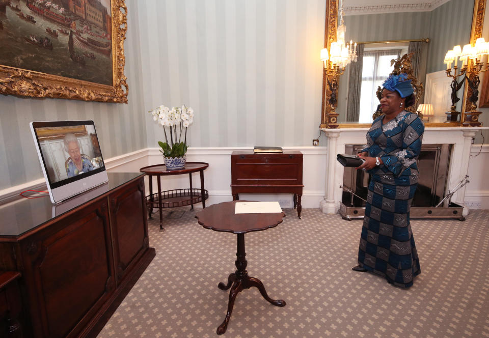 Queen Elizabeth II appears on a screen by videolink from Windsor Castle, where she is in residence, during a virtual audience to receive Her Excellency Sara Affoue Amani, the Ambassador of Cote d'Ivoire, at Buckingham Palace, London. Picture date: Tuesday April 27, 2021.