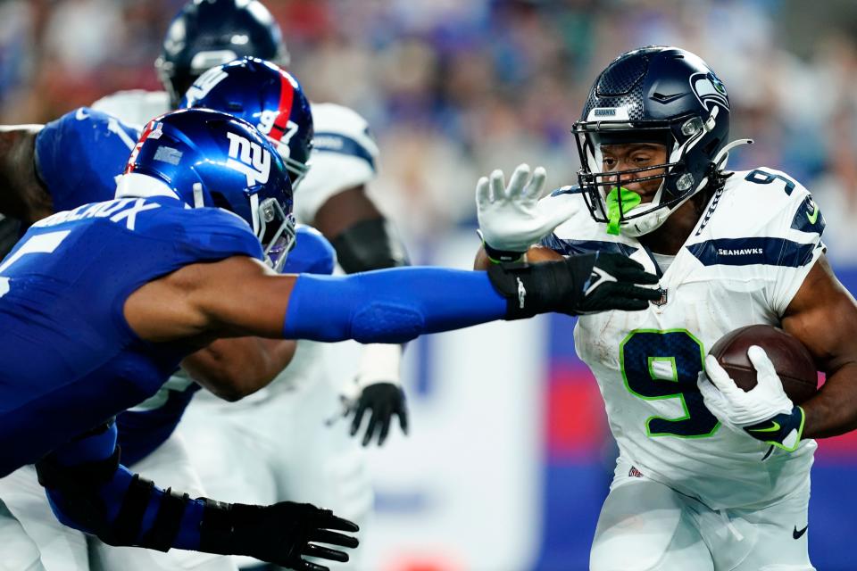 Seattle Seahawks running back <a class="link " href="https://sports.yahoo.com/nfl/players/33996" data-i13n="sec:content-canvas;subsec:anchor_text;elm:context_link" data-ylk="slk:Kenneth Walker III;sec:content-canvas;subsec:anchor_text;elm:context_link;itc:0">Kenneth Walker III</a> (9) rushes with pressure from <a class="link " href="https://sports.yahoo.com/nfl/teams/ny-giants/" data-i13n="sec:content-canvas;subsec:anchor_text;elm:context_link" data-ylk="slk:New York Giants;sec:content-canvas;subsec:anchor_text;elm:context_link;itc:0">New York Giants</a> linebacker <a class="link " href="https://sports.yahoo.com/nfl/players/33960" data-i13n="sec:content-canvas;subsec:anchor_text;elm:context_link" data-ylk="slk:Kayvon Thibodeaux;sec:content-canvas;subsec:anchor_text;elm:context_link;itc:0">Kayvon Thibodeaux</a> (5) in the first half at MetLife Stadium on Monday, Oct. 2, 2023, in East Rutherford.