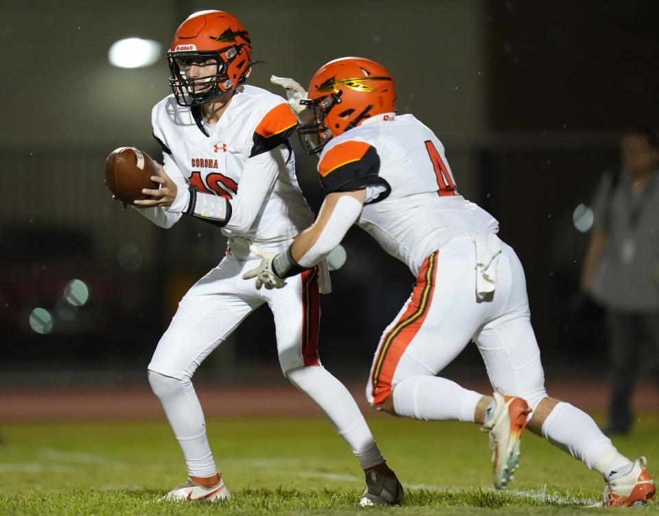 Corona del Sol quarterback Connor Ackerley fakes a hand off to Jonathan Kubat during their game at Chandler High School on Friday, Sept. 9, 2022. 