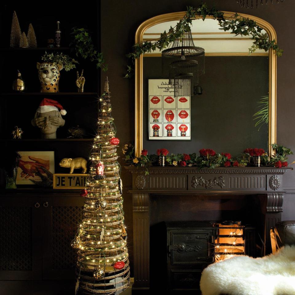 St George’s love of dark hues is on full display in her sitting room. ‘When you decorate a room, you have to have a starting point,’ she says. ‘We had a brown sofa and I wanted to match the colours tonally to create an immersive feeling.’ The walls are painted in Briarwood from RSG’s paint range with Craig & Rose, accented by gold woodwork -  Claire Worthy