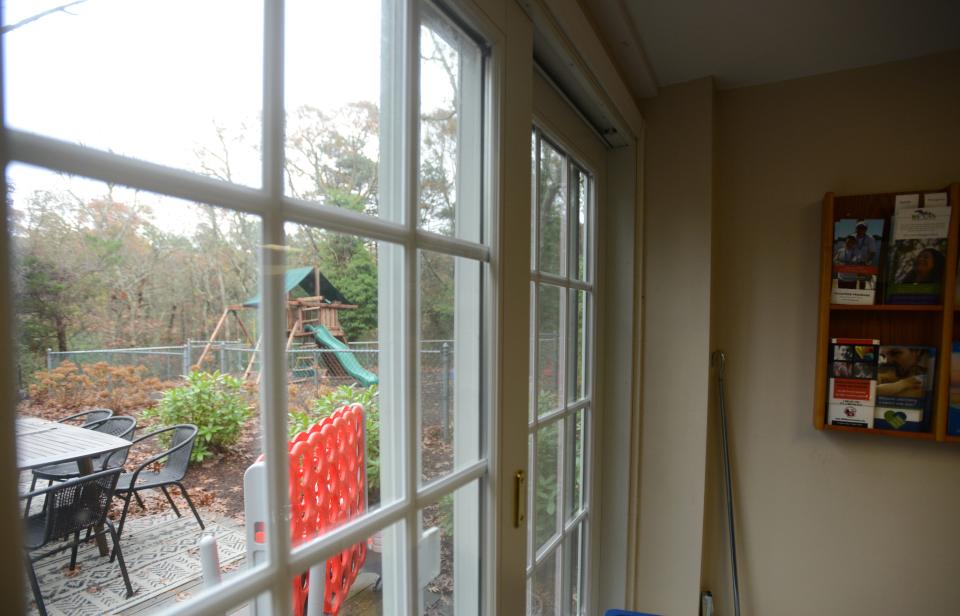 A deck and playground seen through the waiting room area at the Cape and Islands Child Advocacy Center, Children's Cove.